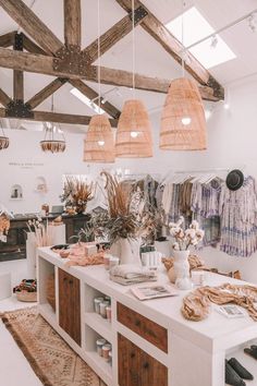 a room filled with lots of furniture and hanging lights over it's counter top