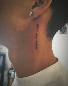 a man with a small tattoo on his neck