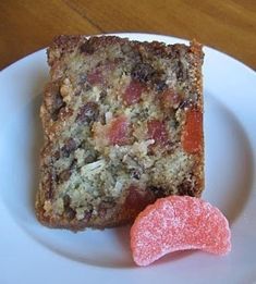 a piece of cake sitting on top of a white plate next to a pink heart