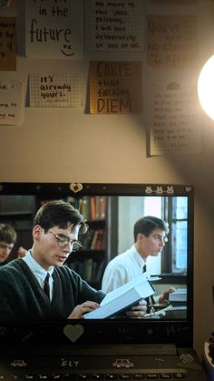 there is a television screen with the image of harry potter on it and people in the background