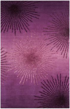 an area rug with purple and gold stars on it, in the shape of fireworks