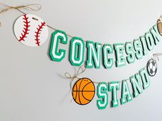 there is a sign that says concesion stand next to a baseball and basketball