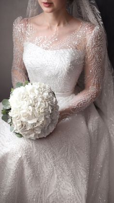 a woman in a wedding dress holding a bouquet