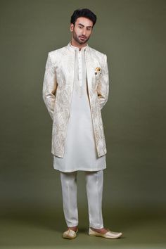 Off white open sherwani with mandarin collar, all over geometric abstract pattern, monotone resham and sequin embroidery. Paired with kurta with embroidered yoke and straight pant.
Components: 3
Pattern: Embroidered
Type Of Work: Resham and Sequin Work
Neckline: Mandarin Collar
Sleeve Type: Full Sleeves
Fabric: Crepe, Handloom Silk, Terry Rayon
Color: Off White
Other Details: 
Embellished buttons
Side slits on kurta
Kurta Closure: Front button placket
Note: The brooch and pocket square worn by t Elegant White Bandhgala Straight Kurta, White Bandhgala With Dabka For Eid, White Elegant Nehru Jacket For Designer Wear, Elegant White Nehru Jacket For Designer Wear, White Formal Sets For Transitional Season, White Nehru Jacket With Naqshi For Transitional Season, Formal White Kurta With Dupatta, White Nehru Jacket With Dupatta For Eid, White Dabka Sherwani For Eid