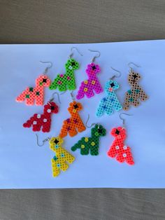 the pixelated earrings have been made to look like teddy bears and are hanging from hooks