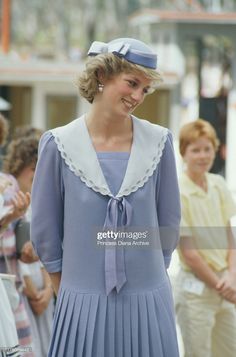 the princess of wales smiles as she walks with other people