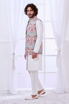 White Nehru jacket with thread embroidery in floral pattern. - Aza Fashions White Nehru Jacket With Floral Embroidery For Spring, Spring White Nehru Jacket With Floral Embroidery, White Cotton Nehru Jacket With Floral Embroidery, White Embroidered Nehru Jacket For Spring, Festive Nehru Jacket With Stand Collar For Spring, Sleeveless Nehru Jacket For Spring Wedding, Spring White Embroidered Nehru Jacket, Spring Embroidered White Nehru Jacket, Cotton Nehru Jacket For Spring Wedding