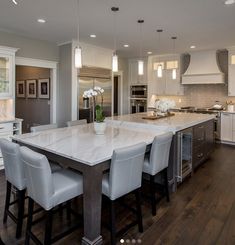 a large kitchen with an island in the middle