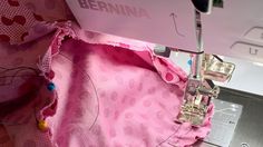 someone is using a sewing machine to sew the fabric on a piece of cloth