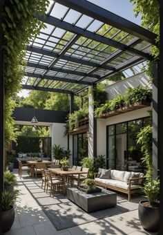 an outdoor patio with lots of plants and furniture