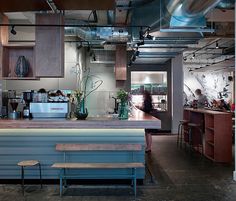 an industrial style kitchen and dining area in a commercial building with lots of light fixtures