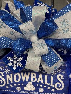 a blue and white bow with snowballs on it