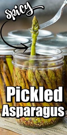 pickled asparagus in a glass jar with text overlay saying spicy pickled asparagus