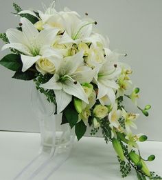 a bouquet of white flowers in a clear vase