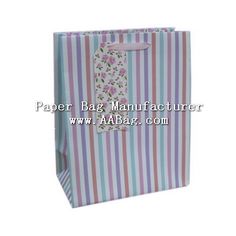 a paper bag with flowers and stripes on the front, it is blue and pink