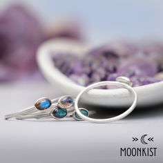 This dainty Silver Oval Labradorite Stacking Ring Set features a 6 x 4 mm oval cabochons, shown here in Labradorite. The bands have a smooth round wire band, shown here with a matte finish. These rings fit together as a stacking ring set and look great. Due to the nature of labradorite, individual pieces vary in color, but the stones we use all have sheen, color play, and depth. Sterling Silver Stacking Rings, 6 x 4 mm Cabochon Stones Dimensions: - Each Band: 1 mm (approx. 0.01 in), From Finger Sterling Silver Stacking Rings, 2 Rings, Stacking Ring Set, Color Play, Silver Stacking Rings, Ring Fit, Stacking Ring, Stacking Rings, Free Jewelry