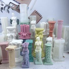 many different colored vases sitting on top of each other