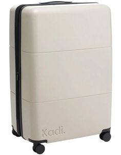 a white piece of luggage on wheels with the word kadi written in black lettering