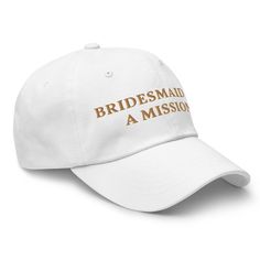 a white baseball cap with the words bridesmaid, a mission written on it