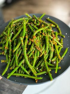 green beans with seasoning on a plate ready to be cooked in the oven for dinner