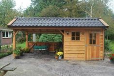 a wooden shed with a table and chairs in it