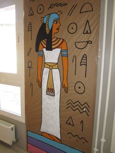 an egyptian mural on the side of a wall in a room with a radiator