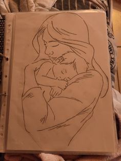 a drawing of a woman holding a baby in her arms on top of a bed