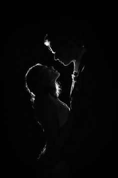 black and white photograph of a couple in the dark