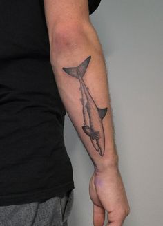 a man with a shark tattoo on his arm