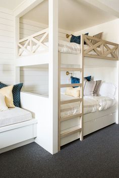 a room with bunk beds and white walls