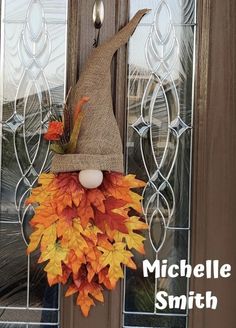 a door hanger with a scarecrow hat on it