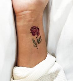 a woman's foot with a flower tattoo on it