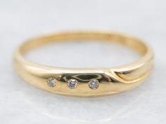 Also, known as a gypsy setting, this bezel set three-diamond band is beautiful in its simplicity! The three diamonds sparkle and twinkle next to the polished yellow gold, which radiates with warmth. This versatile ring could be stacked with other rings, or worn as a wedding band!Metal: 18K Yellow GoldGem: 3 Diamonds totaling .02 Carats, VS-SI in Clarity, G-H in ColorWidth of Band: 3.8 mmHeight off Finger: 2.1 mmRing Size: 6.25Marks: �“750” Stamped on the inside band Pearl And Diamond Ring, Three Stone Diamond, Engagement Ring Diamond Cut, Diamond Cocktail Rings, Rose Gold Band, Diamond Rings Bands, Halo Diamond Ring, White Gold Band, Anniversary Bands