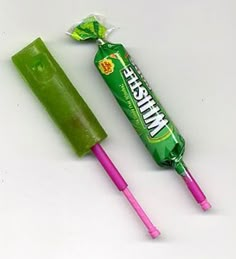 two candy bars with the words who remembers this noisy candy? on them and an image of a green stick