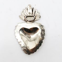 This gorgeous German silver heart is handmade by the Rodriguez family in San Miguel de Allende. Details: This heart is hand engraved and composed of German silver. German silver is a metal made by combining nickel, copper, and zinc and *does not* contain silver. Dimensions: approximately 3 x 2 inches Includes hook on the back so you can hang on the wall or use for other decorative purposes such as jewelry or an ornament. German Silver, Heart Ornament, Hand Engraving, Silver Heart, Copper, Rings For Men, Silver Rings, Silver