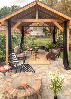 an outdoor living area with patio furniture and fire pit