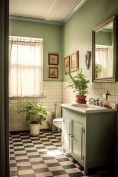 a bathroom with green walls and checkered flooring, potted plants on the counter