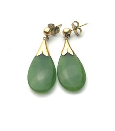 Gorgeous tear drop  dangle earrings. A green gemstone in a smooth pebble tear drop shape, 0.75" by 7/16" and 1/8" thick. Set on a yellow gold for pierced earrings. The push back butterfly are not original. 1 1/8" drop. In excellent condition with expected signs of wear. The stone has no cracks nor scratches. The gold has very minor surface scratches. Comes in a gift box, pack with care. Yellow Gold Gemstone Teardrop Earrings, Formal Teardrop Pierced Drop Earrings, Formal Teardrop Shaped Pierced Earrings, Yellow Gold Teardrop Dangle Earrings With Gemstone, Pierced Drop Earrings, Classic Green Pear Shaped Earrings, Classic Green Pear-shaped Earrings, Gold Teardrop Gemstone Earrings, Teardrop Gemstone Earrings In Yellow Gold