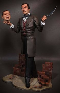 a statue of a man holding two knives in one hand and wearing a suit on the other