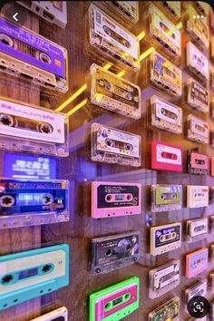 a wall full of old school cassette tapes and tape recorders, all in different colors