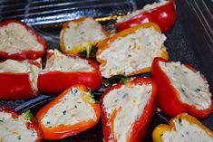 several peppers with cheese on them sitting in a pan