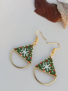 Each snowflake falling to the world is different from the other and has a unique beauty.  You can feel unique or express that someone you love (your lover, mother, friend or sister) is unique and very valuable to you by gifting this earring.  This snowflake earring, which I made with high quality Christmas-themed miyuki beads and brick stitch technique, is a wonderful handmade gift for Christmas with its green, red, silver, gold beads, half brass ring and gold-plated ear wire. These earrings are brick stitch woven with miyuki delica beads and strong thread to last a life time. Lightweight and comfortable, these earrings are suitable for everday use and complement any outfit Beadwork Jewelry, Diy Seed Bead Earrings, Embroidered Hoop, Beaded Fringe Earrings, Beading Jewelery, Brick Stitch Earrings, Snowflake Earrings, Snowflake Christmas, Earrings Beaded