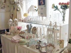 a table covered with lots of glassware and flowers