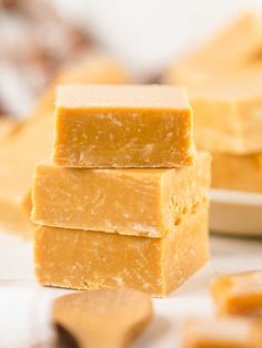 three pieces of yellow fudge are stacked on top of each other