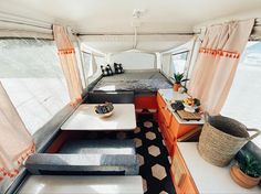 the interior of a camper with orange and white decor