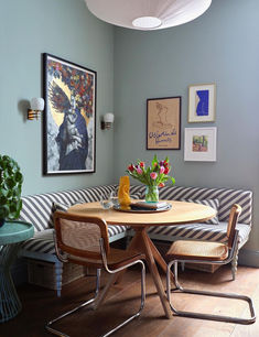 a living room with a couch, table and pictures hanging on the wall above it