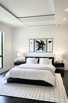 a large white bed sitting in the middle of a bedroom next to two lamps on either side of it