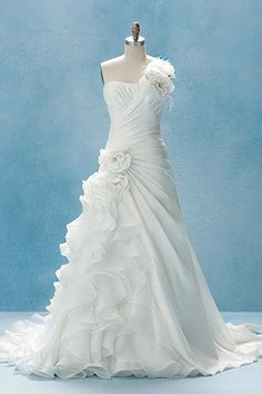 a white wedding dress on display in front of a blue background