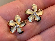 "Solid .925 Sterling Silver w/ 14K Gold Overlay Hawaiian Plumeria Flower 3-stone Stud Earrings. The size is larger at 18MM, just under 3/4\". They have a matte center with high-polished edges w/ three tiny cubic zirconias for a touch of bling. The Gold over the Sterling finish is both stunning, durable and nickel-free. Designed to mimic the look of fine jewelry at a fraction of the cost. --The Plumeria is iconic of Hawaiian culture. It's bright colors and magnificent scent greet both visitors an Gold Flower Earrings, Flower Earrings Gold, Hawaiian Plumeria, Hawaiian Culture, Hawaiian Jewelry, Gold Overlay, Earrings Flower, Stone Studs, Gold Flower