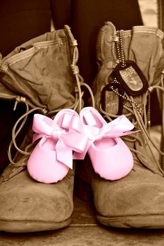 a pair of shoes with pink bows on them